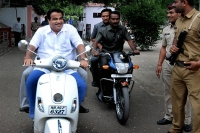 Gadkari courts controversy by riding scooter without helmet