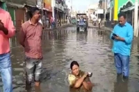 Woman mla takes bath in rain water filled pothole at jharkhands godda to protest