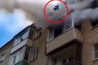 Terrifying moment young family jumps to safety from burning building