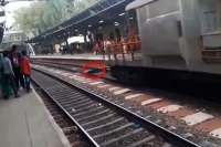 Woman miraculously escapes death after coming under a running train