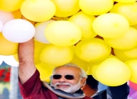 Gujarat CM Narendra Modi holding a bunch of Balloons at the 26th International Kite Festival in Ahmedabad.