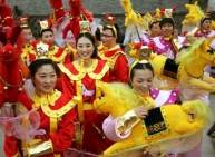 Folk dancers hold horse models as they prepare to take part in a traditional horse dance on the Chinese Lunar New Year Celebrations 2014, at Longtan park in Beijing.