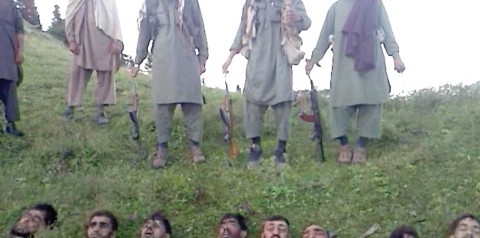 Horrific picture shows armed Taliban militants lording it over 12 decapitated heads of Pakistani 'soldiers' 