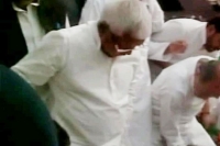 Lalu prasad close aide helping him wear shoes