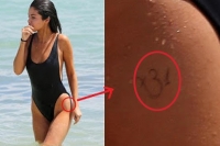 Selena gomez slips into bikini on miami beach shows om tattoo on thigh