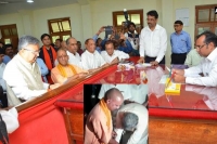 Raman singh touches yogi s feet before filing papers for assembly polls