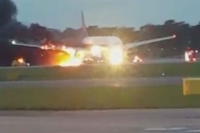 Singapore airlines plane catches fire in emergency landing