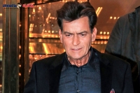 Charlie sheen reveals he s hiv positive in a show and deny the rumours on him