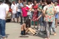 Scorned woman strips her husband s alleged mistress in public