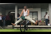 Ms dhoni filmed performing bizarre cycling stunt