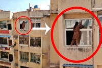Ghaziabad woman cleans window hanging outside 4th floor ledge