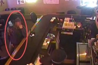 Kissing couple oblivious to armed robbery at montana bar