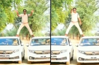 Watch singham stunt mp cop fined for balancing self on two moving cars