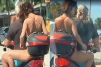 Woman s disgusting act on the back of a motorbike caught on video