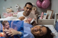 Newborn baby shows her frowning at doctor who tries to make her cry