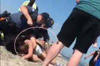 Police launch probe after video shows officer punching woman on nj beach