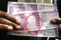 Bank dispenses rs 2000 notes sans gandhi pic says they aren t fake
