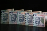 Rupee breaches 65 dollar on continued slide in chinas yuan