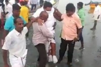 Tamil nadu minister won t wet his shoes fishermen carry him from boat to land